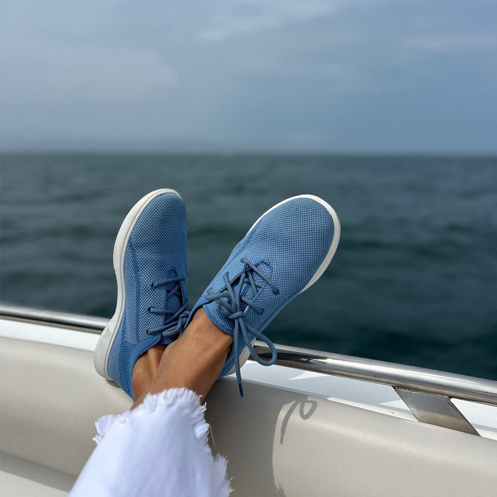 Image of person sitting in a boat wearing Cassia Knit Lace-up